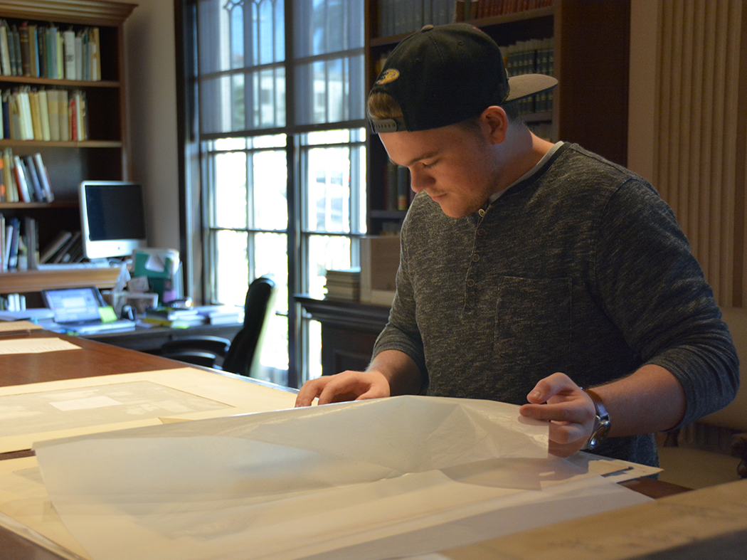 Intern Drew working on cataloguing artwork
