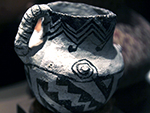 <p>Old Chocolate and Other Surprises: Learning from the May Collection<br />This Snowflake ceramic jar was made ca. C.E. 1200, in the area between present day Interstate 40 and the Mogollon Rim, in Arizona. It has a grayish-white ground with black painted decorations that include parallel zig zag stripes, diagonal stepped elements, and three small pointed protuberances with painted spirals on the upper shoulder.</p><p style="text-align: right;"><em>Photograph by Rose Tyson.</em></p>