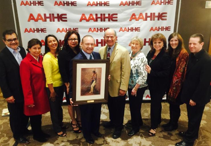 Ted Martinez surrounded by colleagues as he receives the award.
