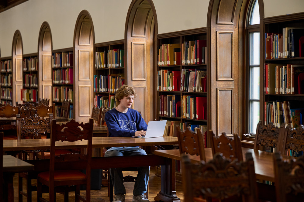 A USD student studies in the library