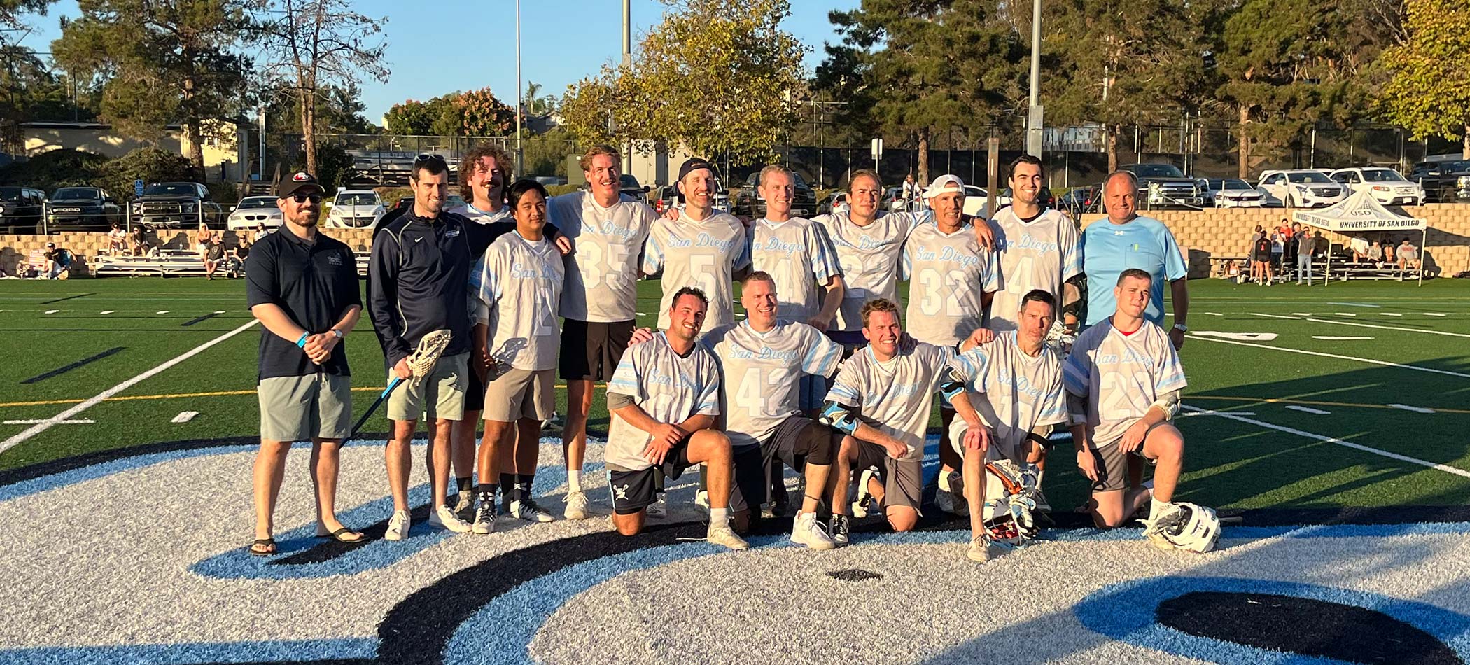 Several assembled lacrosse players.