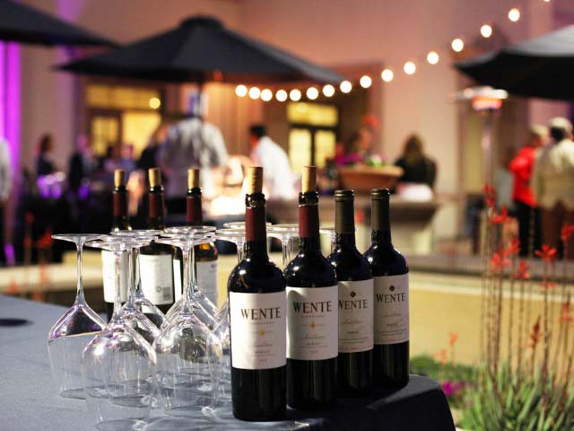 wine glasses and bottles at an event