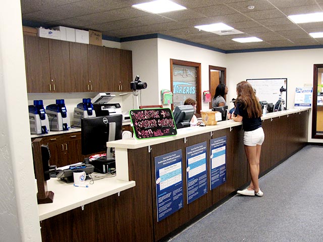 A student at the counter in the Campus Card office
