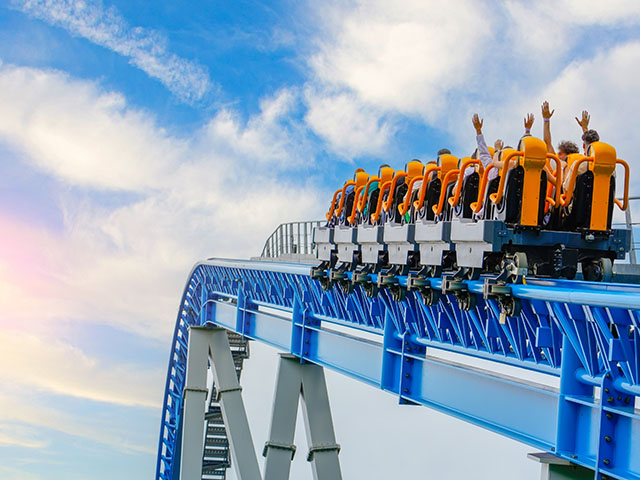 riders on a rollercoaster