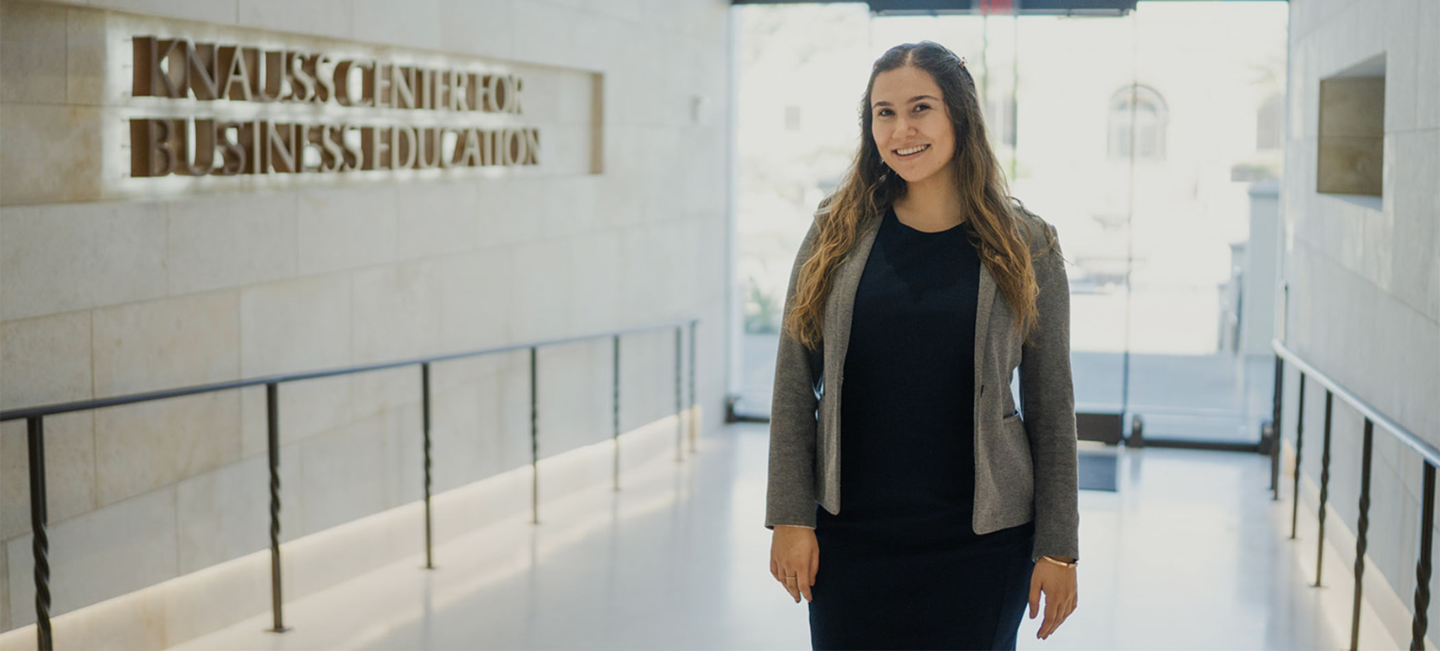 A student walking in the knauss center for business