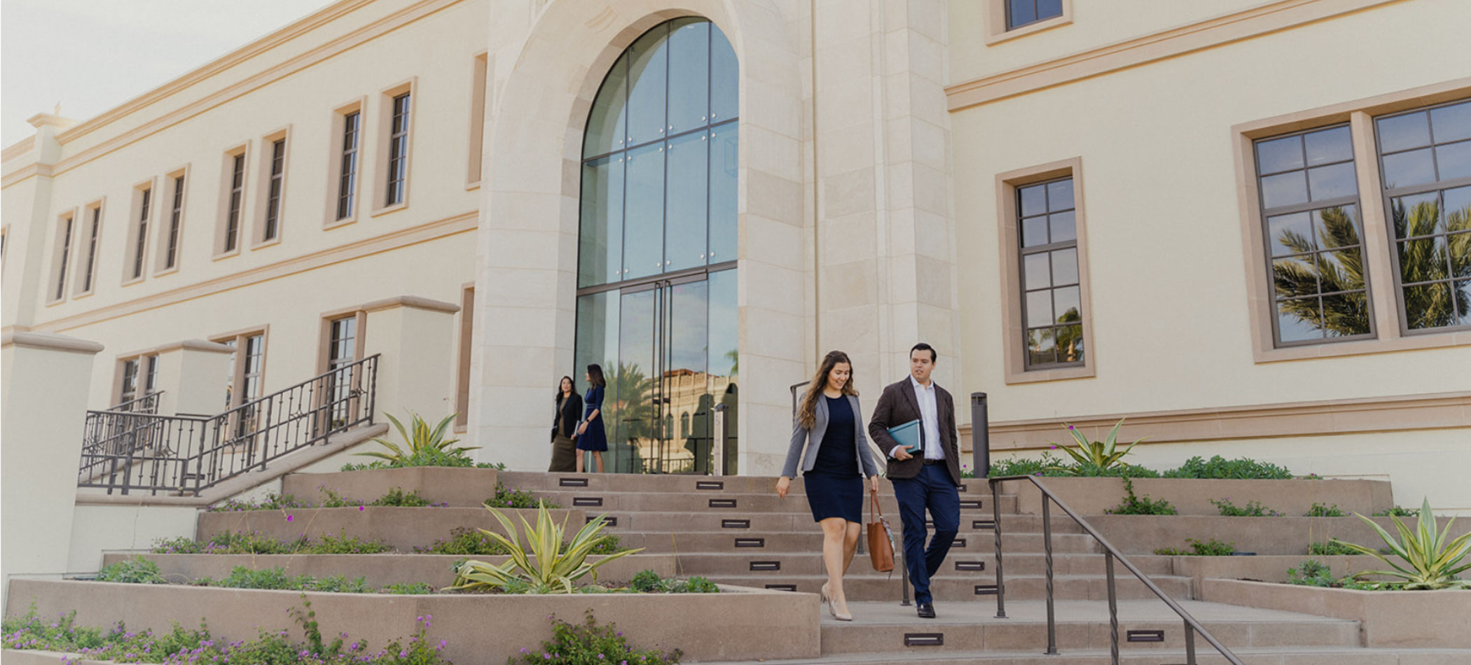 Students walking on the steps of the knauss center for business