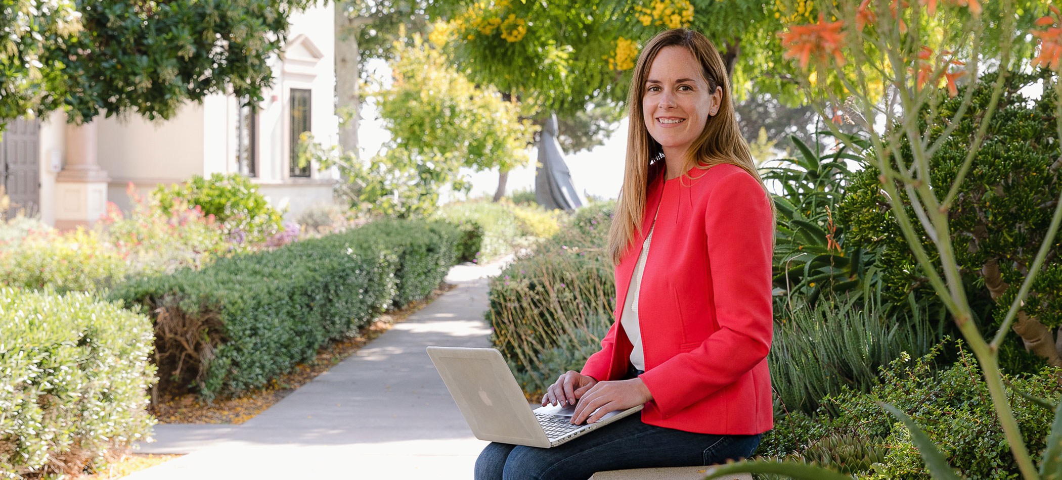 A student works on a laptop outside on the usd campus