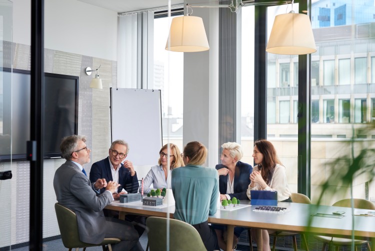 Group of board members meet in a conference room