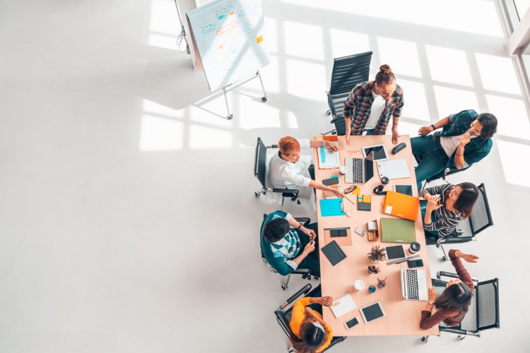 Coworkers sit around a table during a brainstorming session.