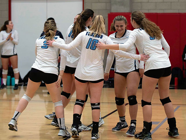 Club volleyball team cheering after a point