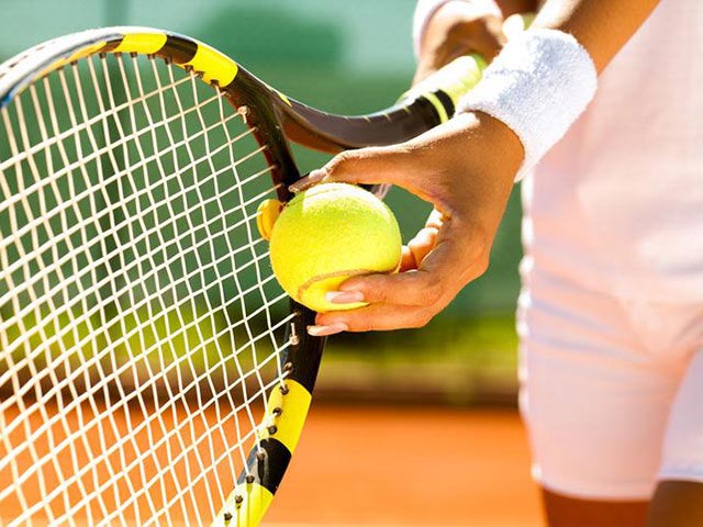 A tennis racket and ball