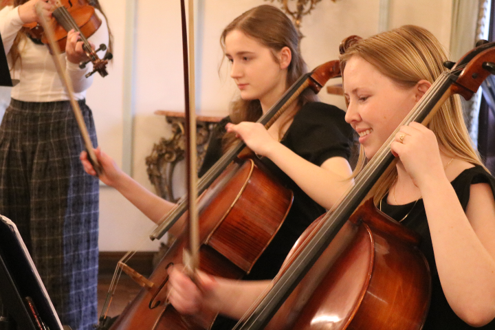 Students playing cellos.
