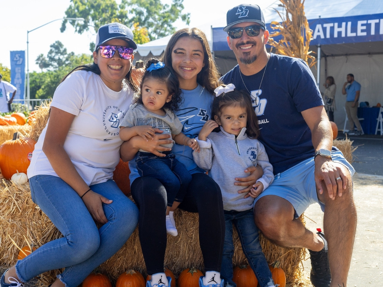A family and kids decked out in USD gear.