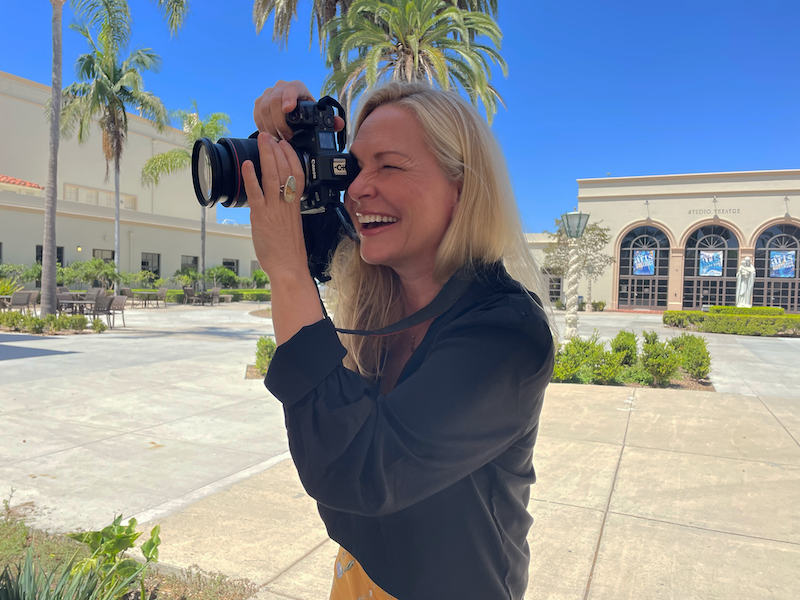 michelle kennedy on holding camera in the Camino/Founders Patio