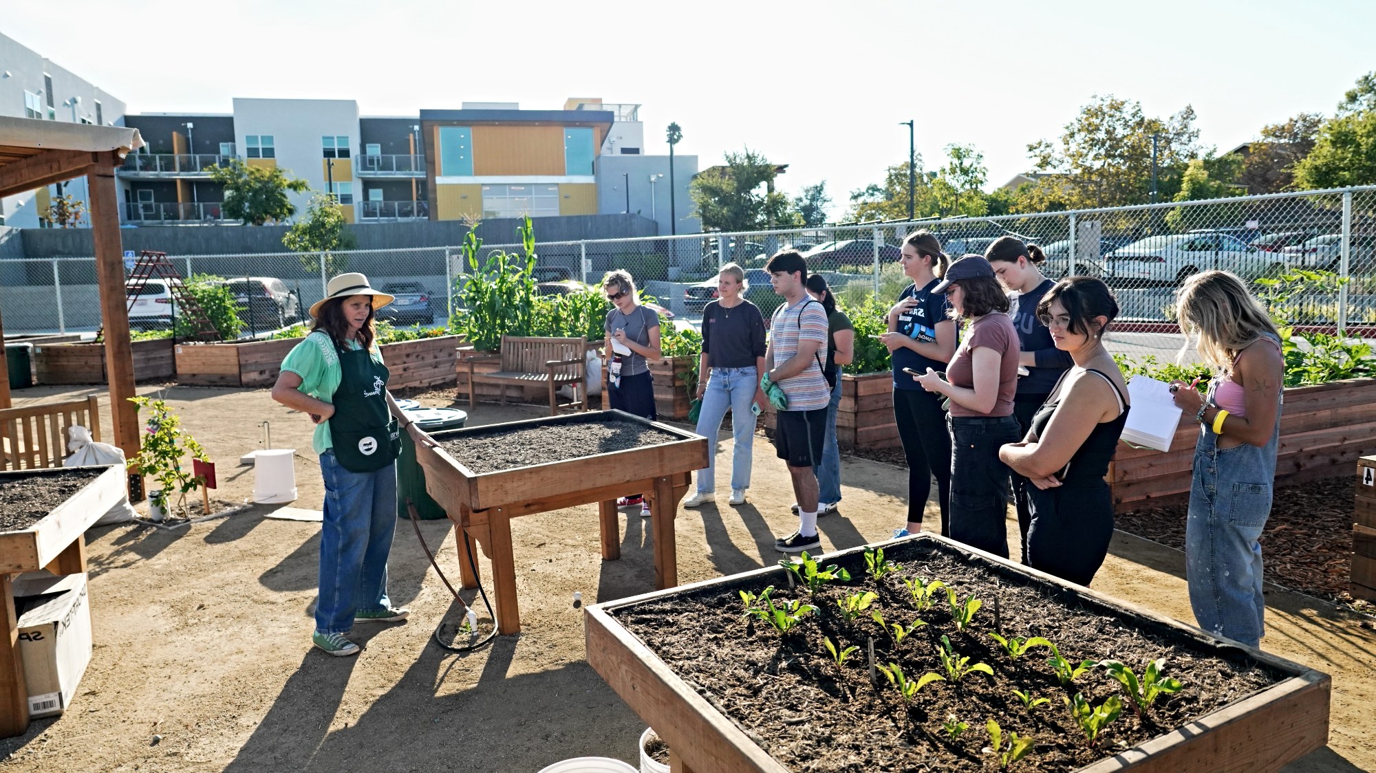 USD class at a community garden listening to a community partner.