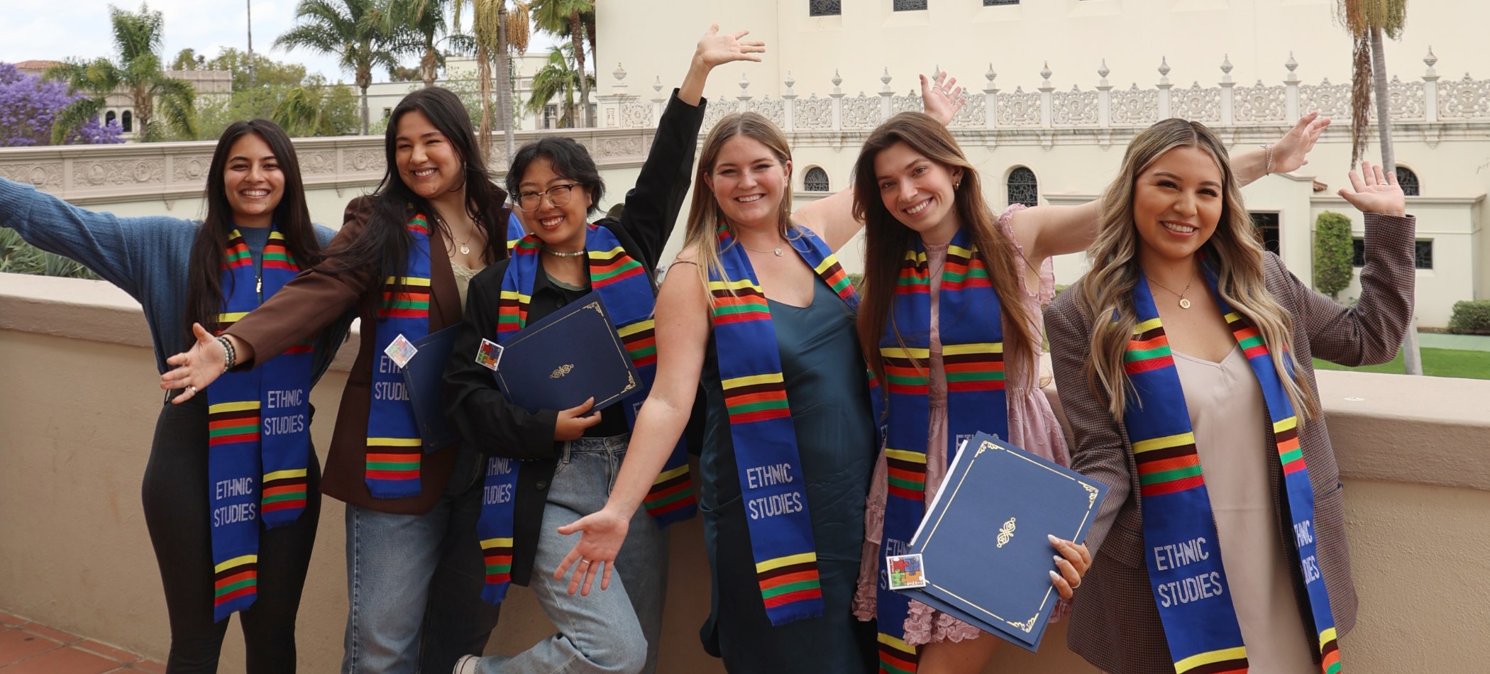 A group of Ethnic Studies majors wearing their graduation robes and Ethnic Studies stoles.