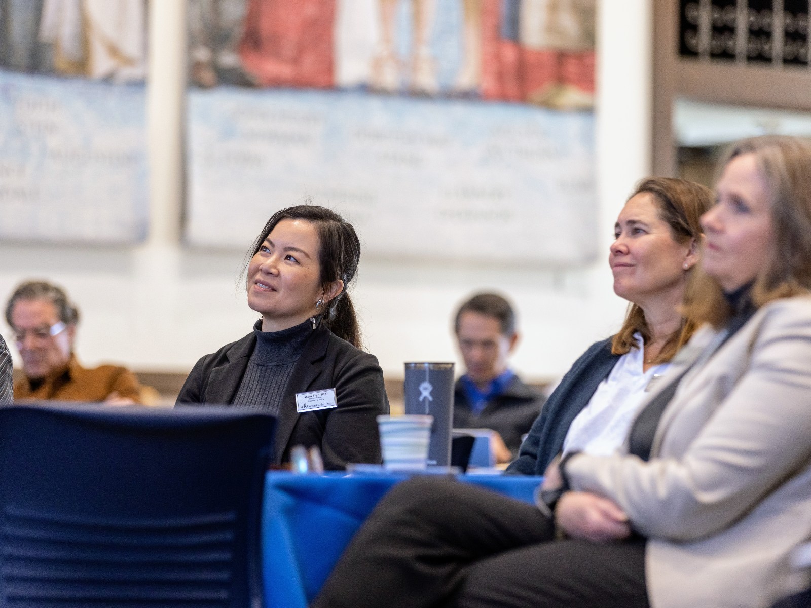 Cawa Tran, PhD, and other faculty from the College of Arts and Sciences at a meeting.