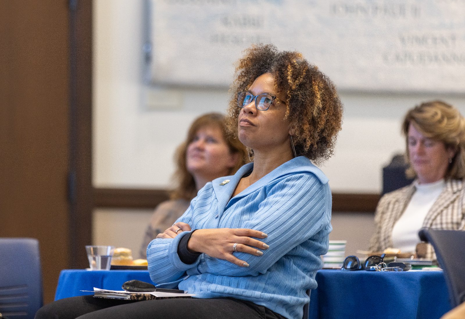 Associate Dean of Faculty Jillian Tullis, PhD, looking up at a projector screen during an event.