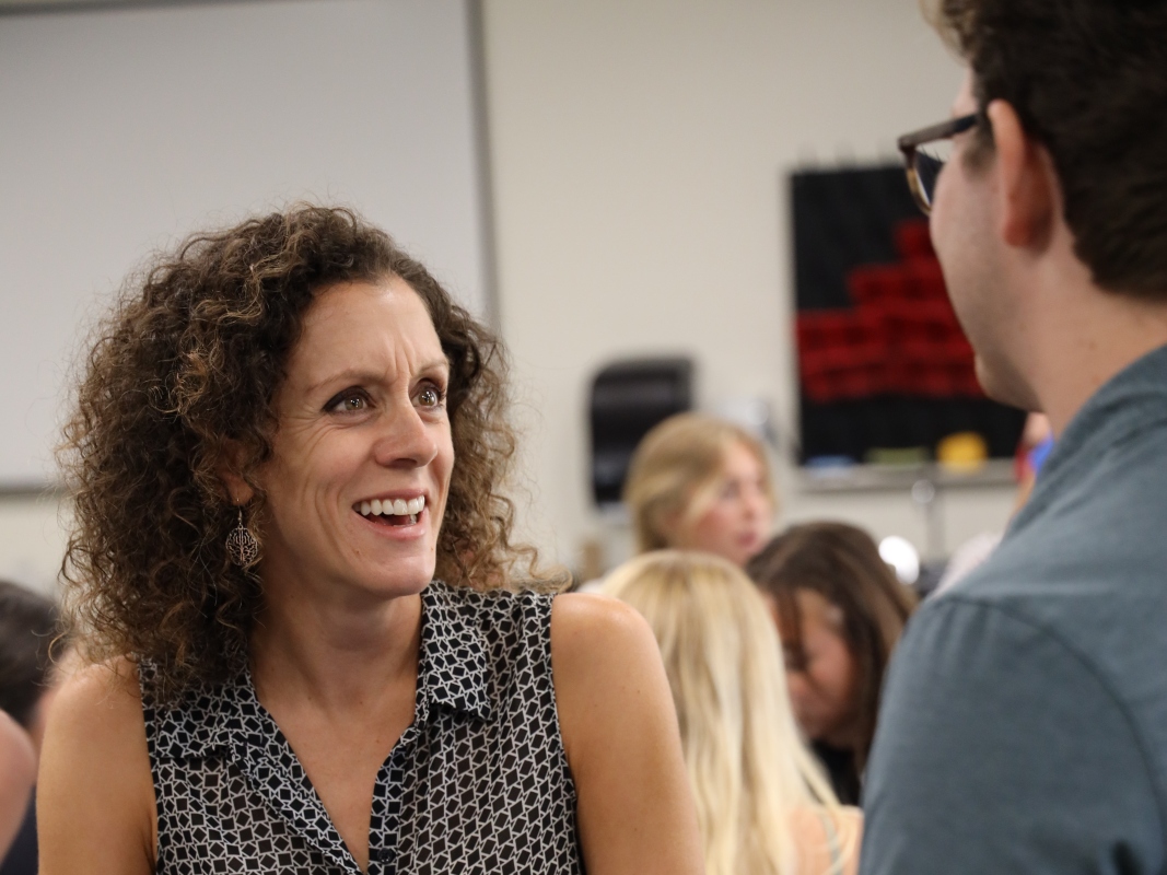 Professor Jena Hales, PhD, speaking with a student.