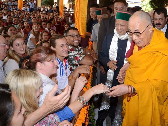 Dalai Lama shaking hands