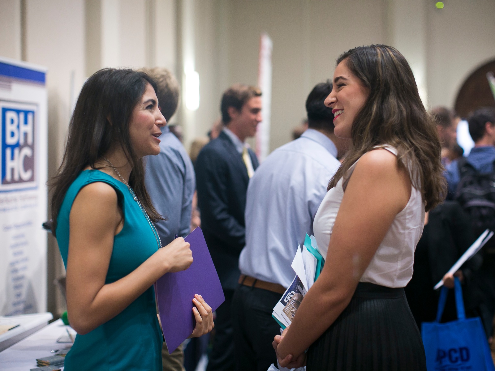 Student talking with recruiter at a career fair.