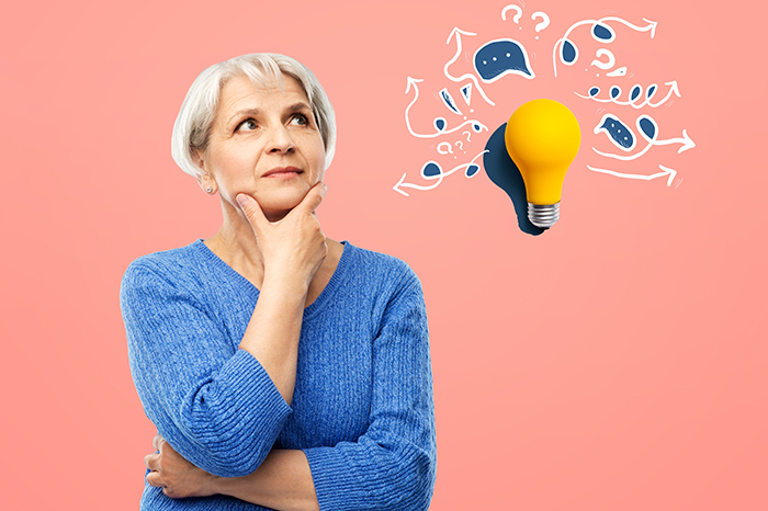 Woman looking up with an expression of thinking. Next to her is a lightbulb.