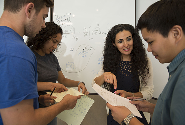 USD faculty member having a conversation with 3 students