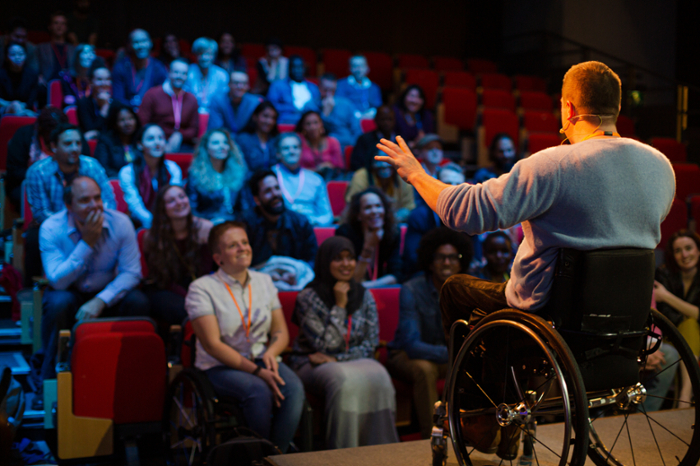 A person speaking in front of an audience.