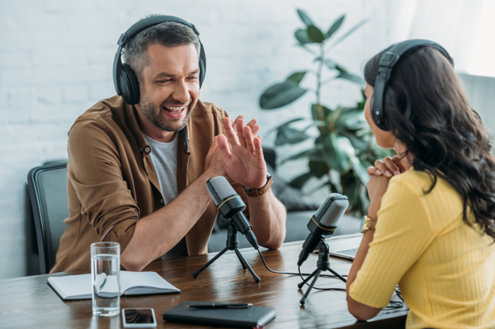 Two people having a conversation on a podcast.