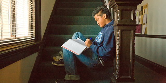 A student sitting on stairs