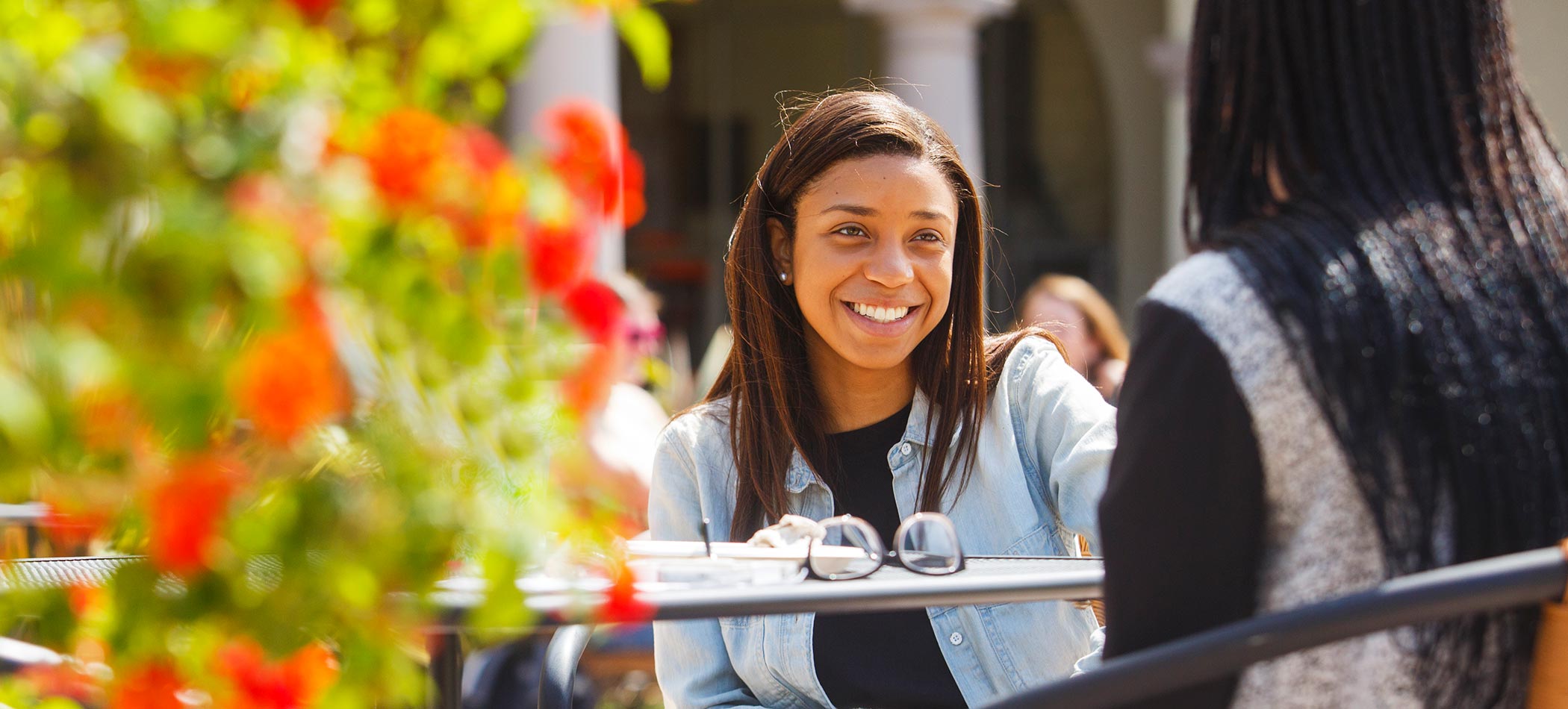 Students talking and smiling on campus