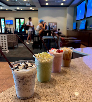 ice cream shakes with students and TVs in background