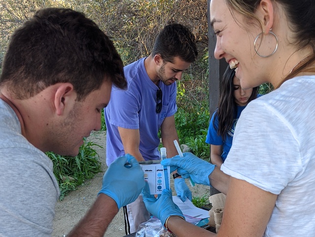woman looking at man with water samples