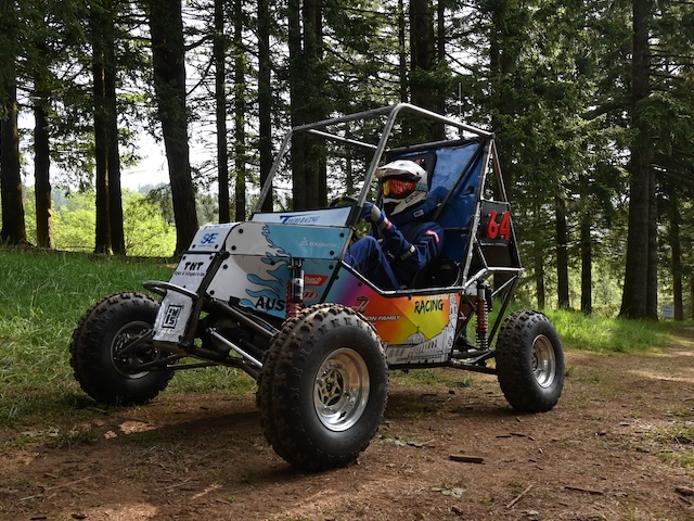 A student sitting in the baja vehicle