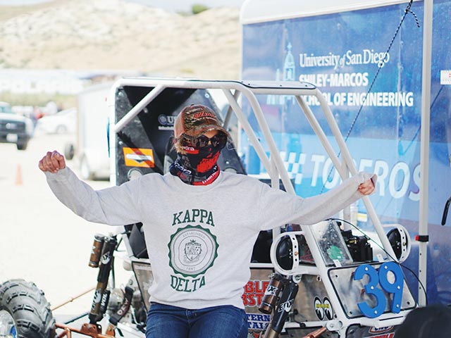 A student sitting in the baja vehicle
