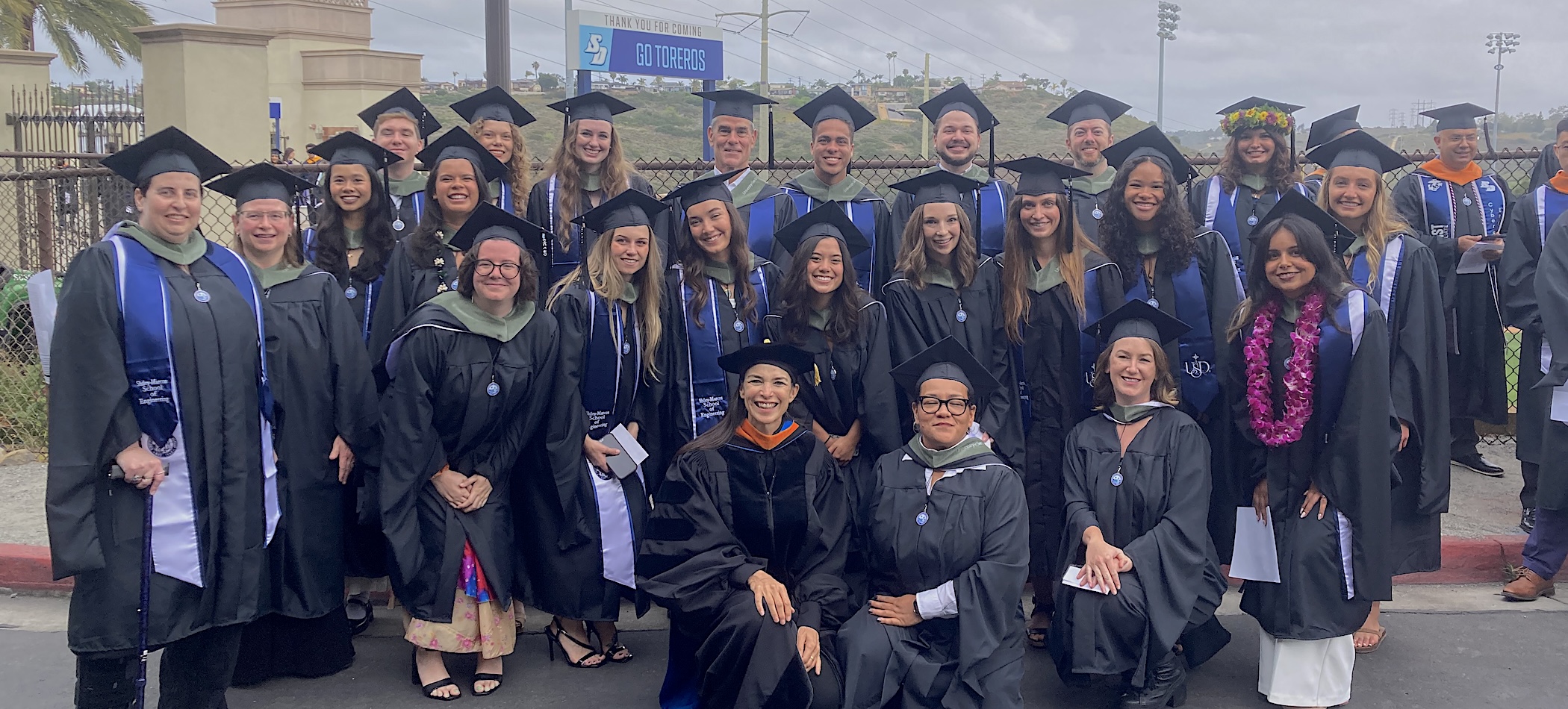 graduates from the combined masters celebrating in regalia