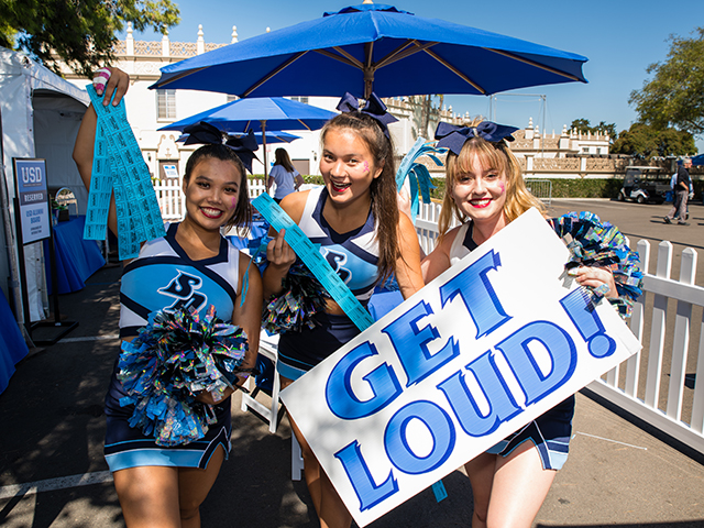 Students holding a Get Loud sign at Homecoming