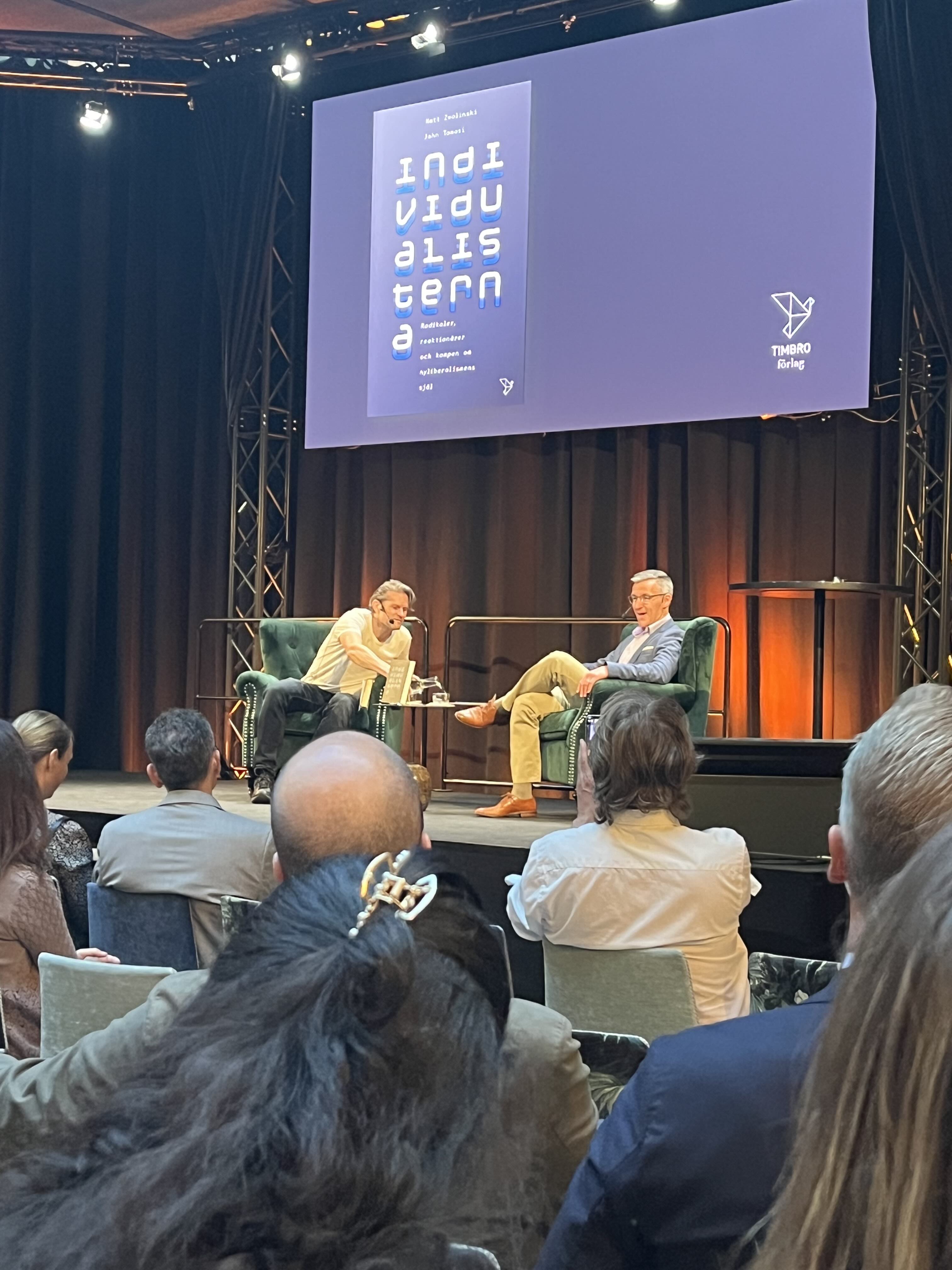 image of speakers on stage at conference