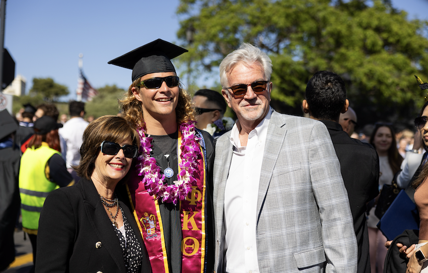 a student with a parent at commencement