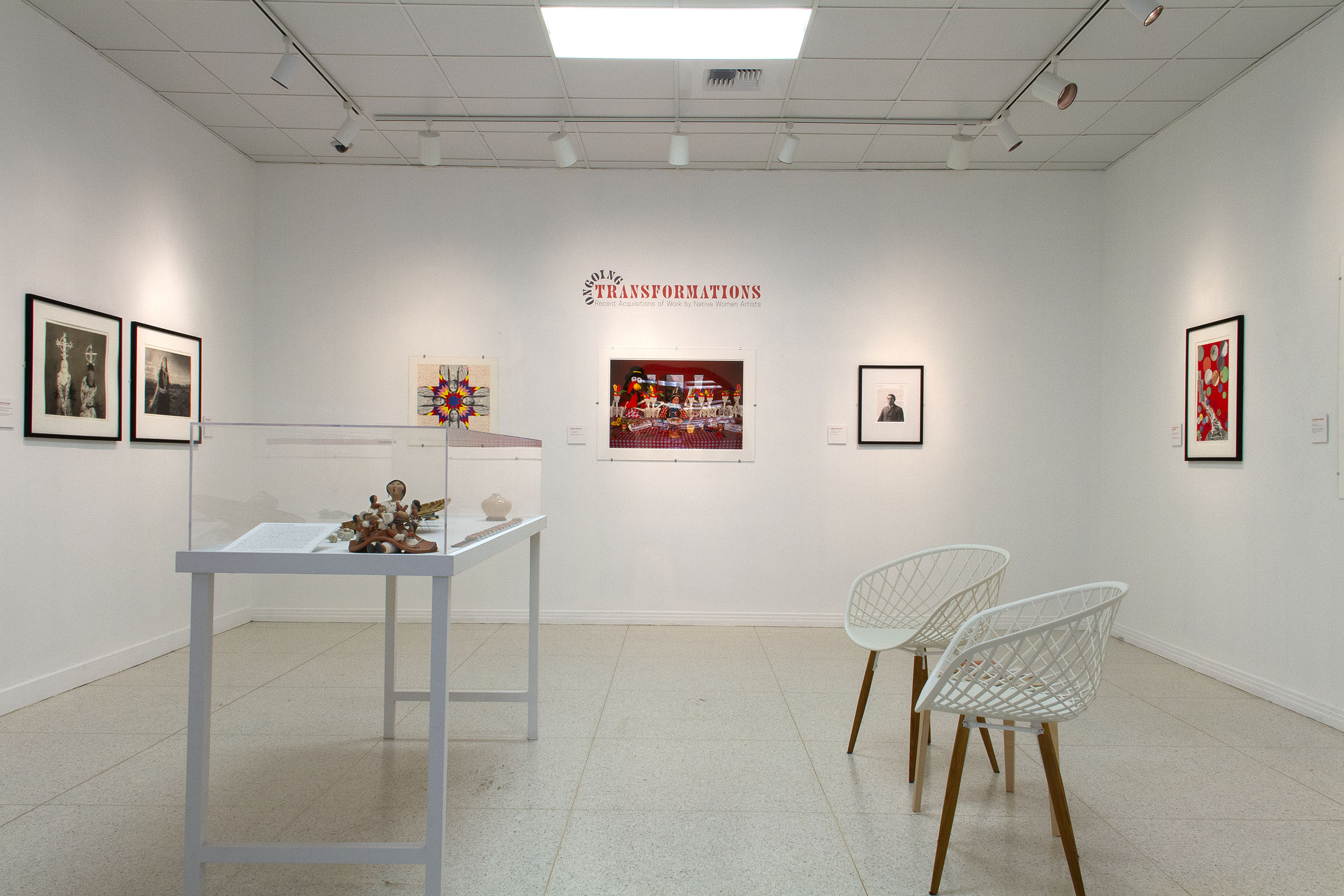 Installation view of a gallery with artworks installed on walls and in a display case