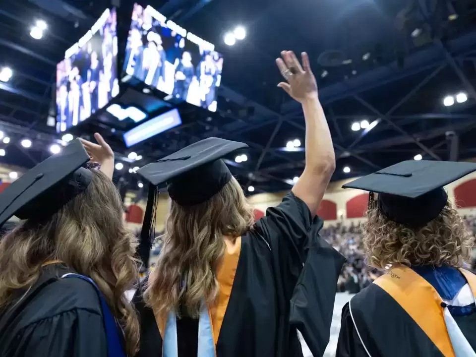 image of students celebrating at commencement ceremony