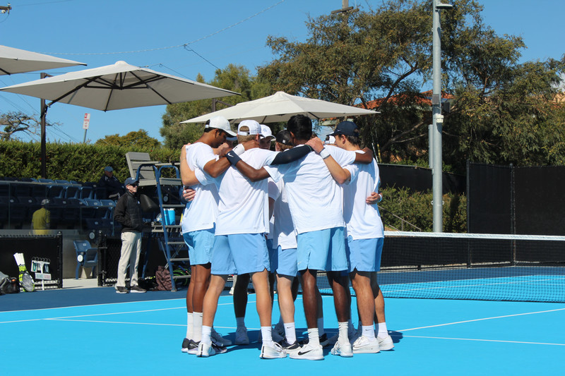 USD men's tennis team huddling