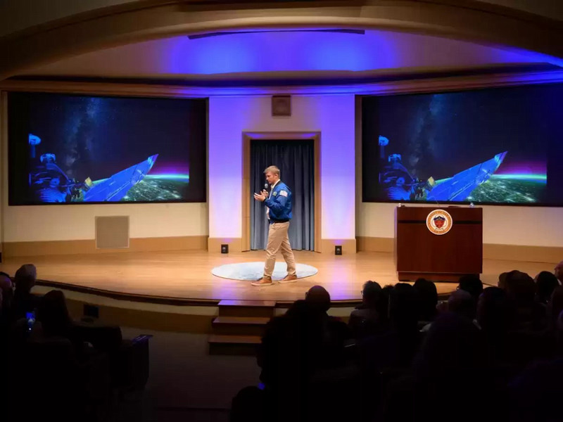 Matthew Dominick speaking on stage.