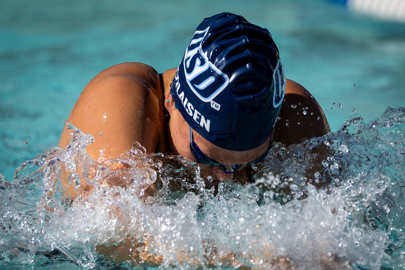 Female USD student swimming competitively