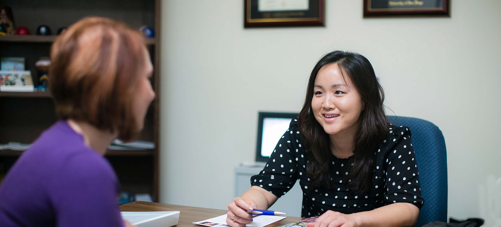 A manager talking with an employee in an office