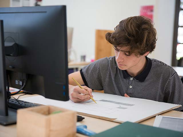 a student writing on a piece of paper