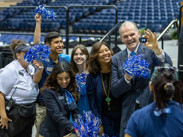 the usd president with students at a sporting event
