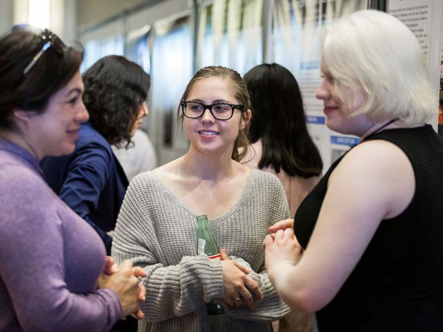 employees talking at an event