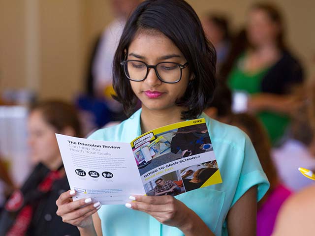 a woman reading a brochure