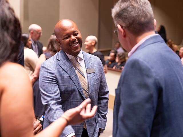 employees talking at an event
